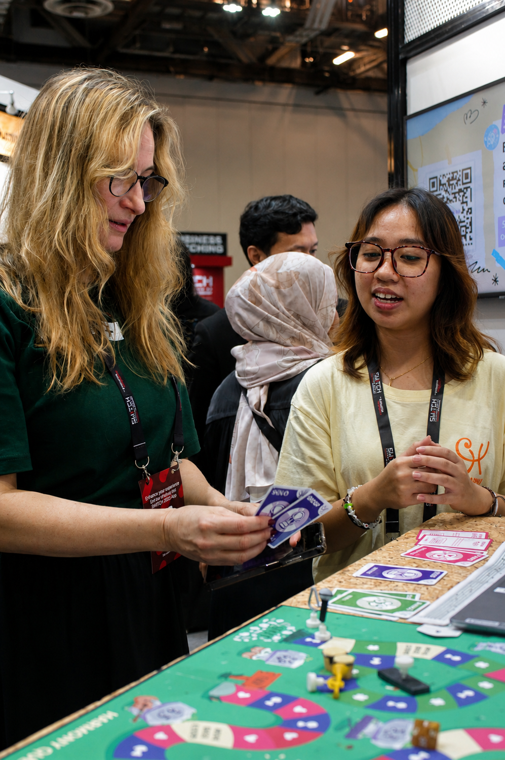 A team member demoing Harmony Quest to a visitor at SWITCH 2025.