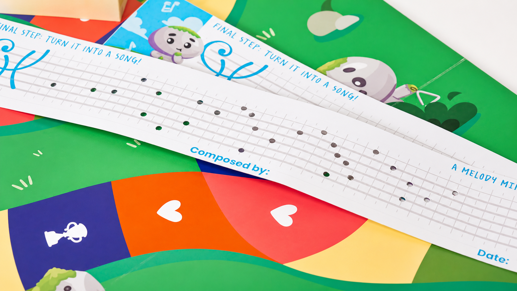 A punched paper melody strip with notes lined up